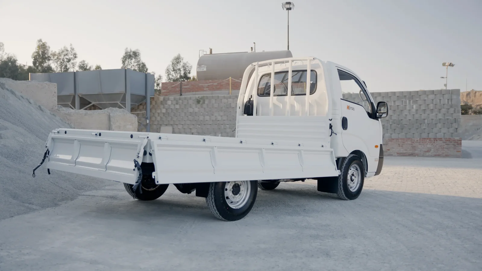 White Kia K2700 dropside bakkie on a work site
